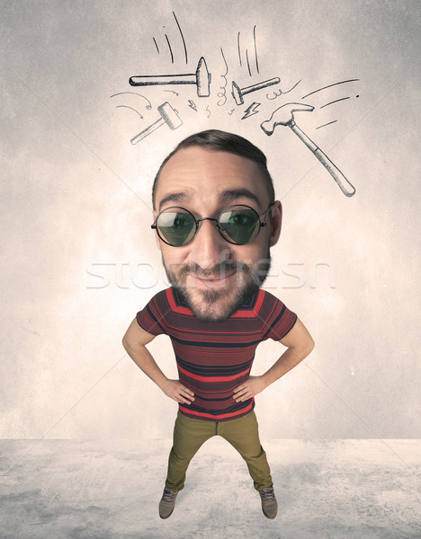 Stock photo: Big head person with drawn hammers