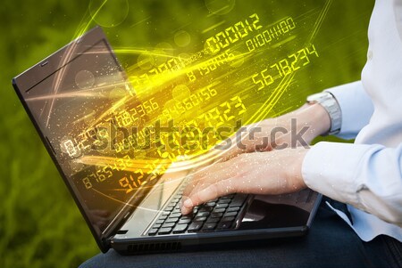 Man typing on modern notebook with number technology data coming Stock photo © ra2studio