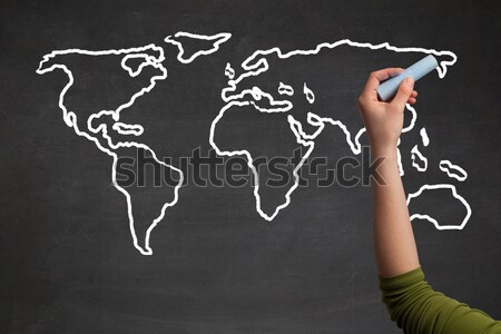 Adult drawing world map on chalkboard Stock photo © ra2studio