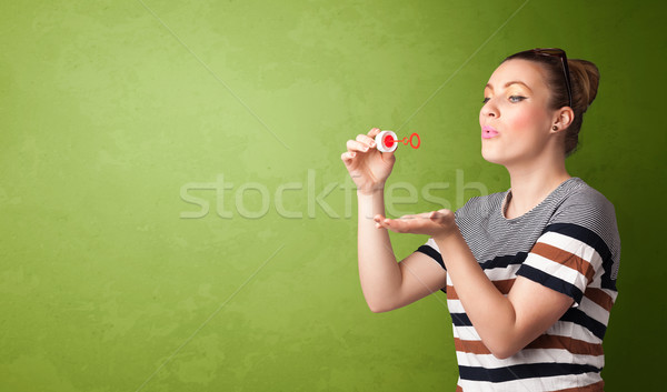 Beautiful woman blowing soap bubble on copyspace background Stock photo © ra2studio
