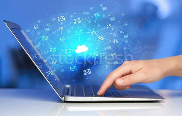Hand using laptop with centralized cloud computing system concep Stock photo © ra2studio