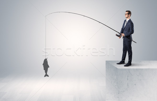 Businessman fishing golden fish concept Stock photo © ra2studio