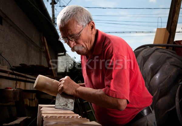 Old woodcarver working with mallet Stock photo © ra2studio