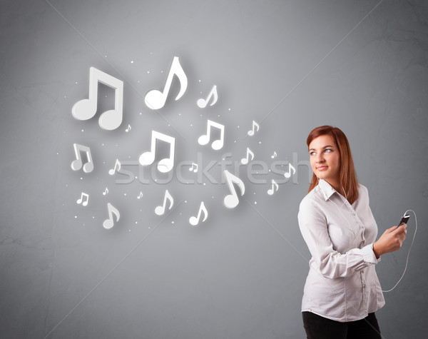 Pretty young woman singing and listening to music with musical notes Stock photo © ra2studio