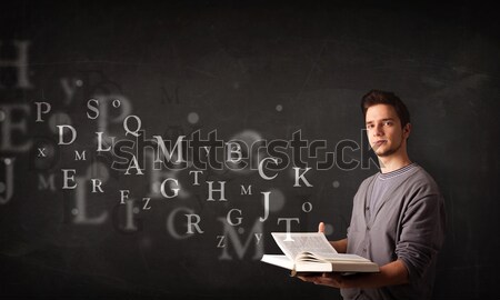 Young man reading a book Stock photo © ra2studio