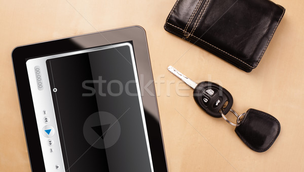 Stock photo: Workplace with tablet pc showing media player and a cup of coffee on a wooden work table closeup