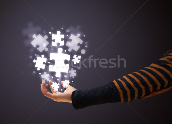 Puzzle pieces in the hand of a woman Stock photo © ra2studio