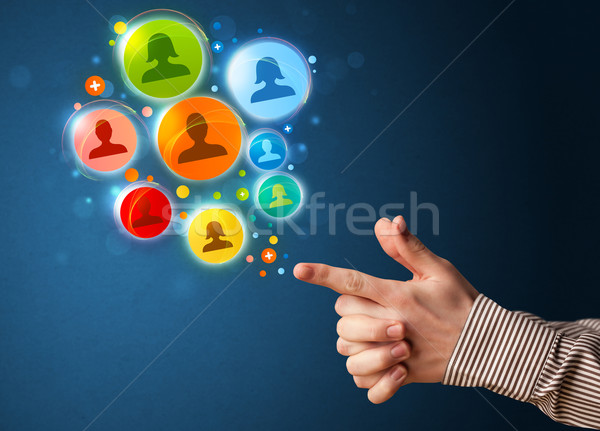 Social media icons coming out of gun shaped hand Stock photo © ra2studio