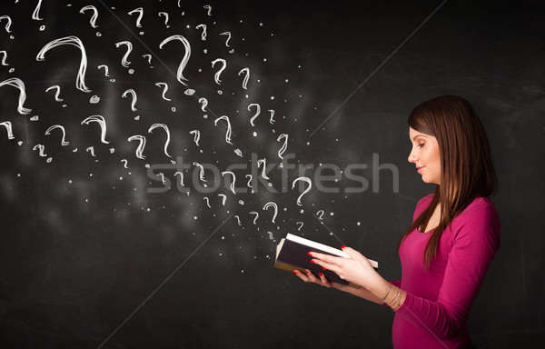 Pretty woman reading a book with question marks coming out from  Stock photo © ra2studio