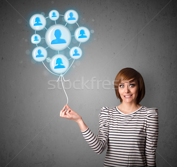 Woman holding social network balloon Stock photo © ra2studio