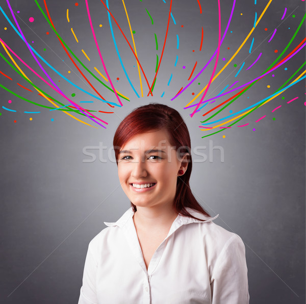 Young girl thinking with colorful abstract lines overhead Stock photo © ra2studio