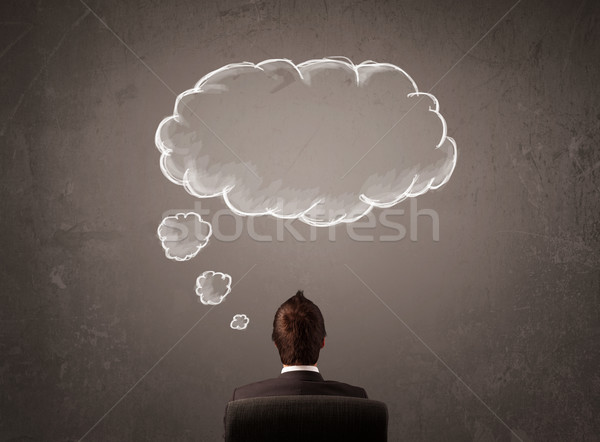 Businessman sitting with cloud thought above his head Stock photo © ra2studio