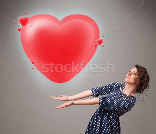 Young lady holding lovely 3d red heart Stock photo © ra2studio