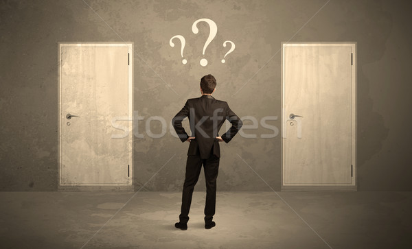 Businessman standing in front of doors Stock photo © ra2studio