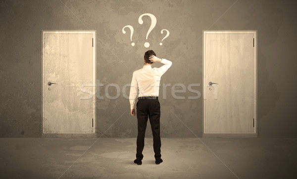 Businessman standing in front of doors Stock photo © ra2studio