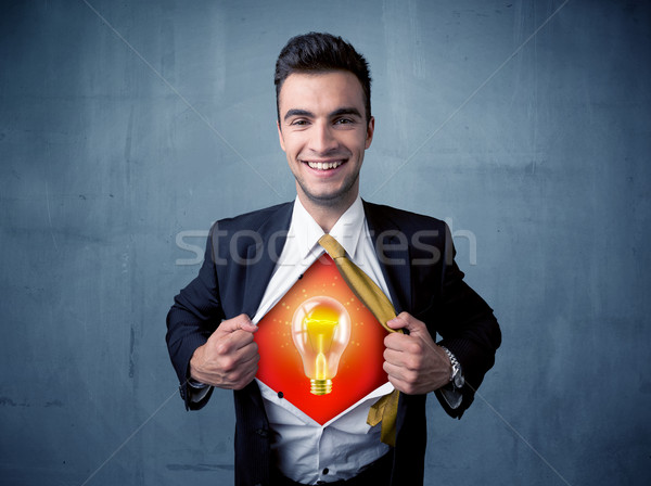 Businessman ripping off shirt and idea light bulb appears  Stock photo © ra2studio