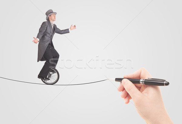 Businessman riding monocycle on a rope drawn by hand Stock photo © ra2studio