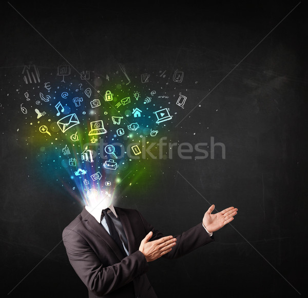 Business man with glowing media icons exploding head  Stock photo © ra2studio