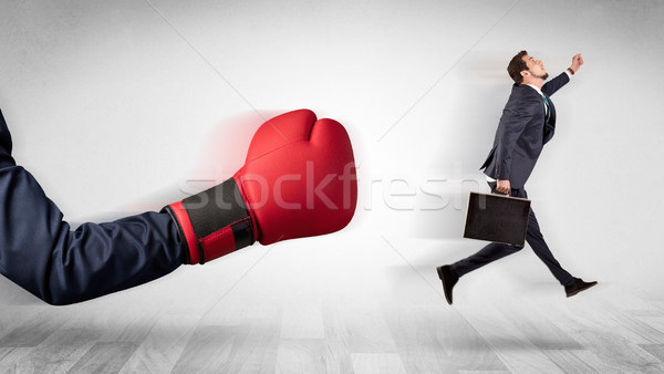 Red boxing glove knocks out little businessman Stock photo © ra2studio