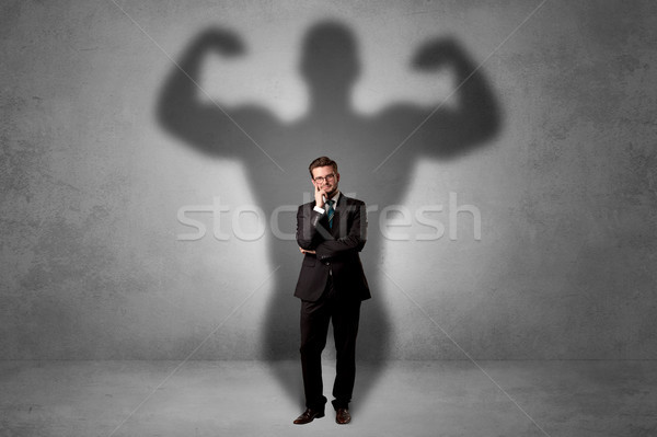 Stock photo: Businessman with muscular shade behind his back