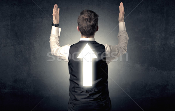 Young businessman standing with arrow on his back Stock photo © ra2studio