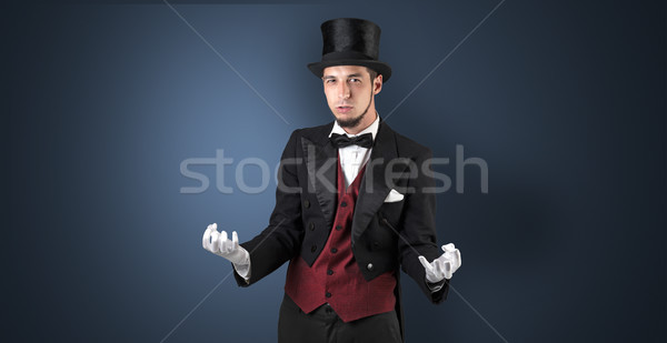 Magician holds something invisible  Stock photo © ra2studio