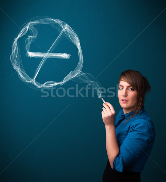 Stock photo: Young lady smoking unhealthy cigarette with no smoking sign