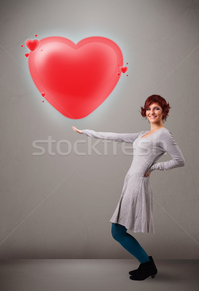 Young lady holding lovely 3d red heart Stock photo © ra2studio