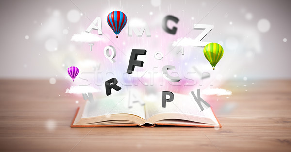 Stock photo: Open book with flying 3d letters on concrete background