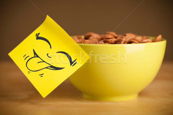 Post-it note with smiley face sticked on cereal bowl Stock photo © ra2studio