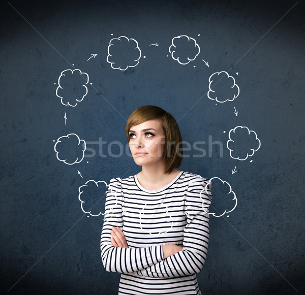 Stock photo: Young woman thinking with cloud circulation around her head