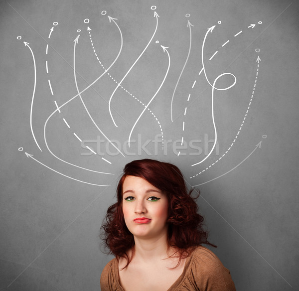 Young woman with arrows coming out of her head Stock photo © ra2studio