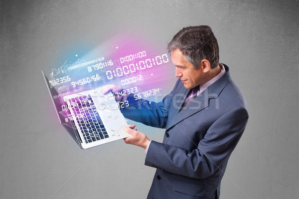 Businessman holding notebook with exploding data and numbers Stock photo © ra2studio