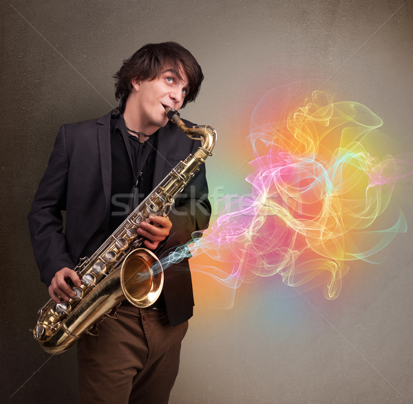 Attractive musician playing on saxophone with colorful abstract  Stock photo © ra2studio