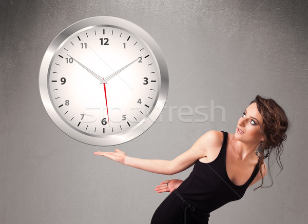 Attractive lady holding a huge clock Stock photo © ra2studio