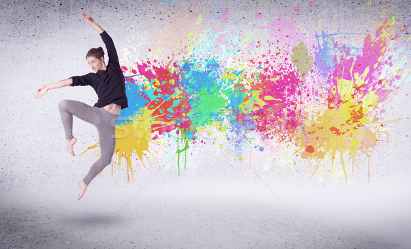 Modern street dancer jumping with colorful paint splashes Stock photo © ra2studio