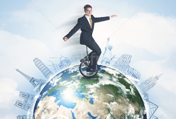 Man riding unicycle around the globe with major cities Stock photo © ra2studio