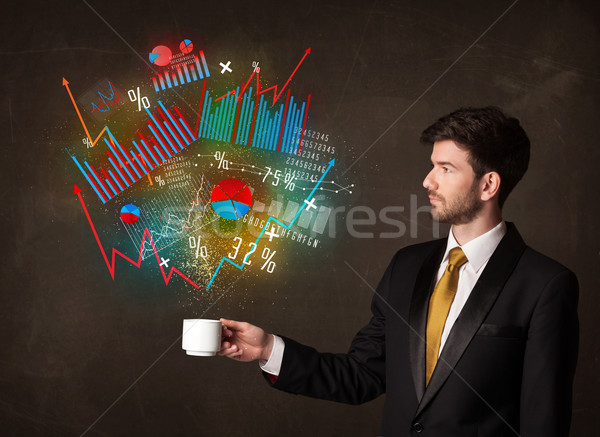 Businessman holding a white cup with diagrams and graphs Stock photo © ra2studio