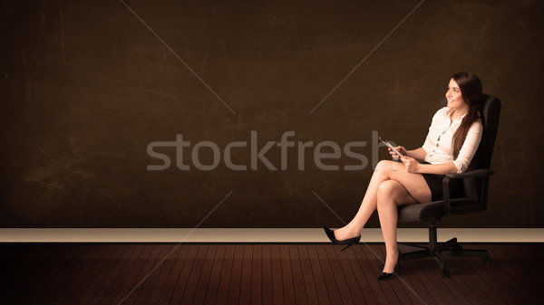 Businesswoman holding high tech tablet on background with copysp Stock photo © ra2studio