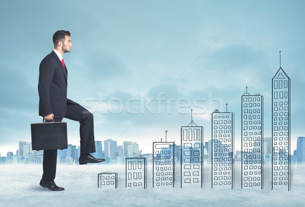 Business man climbing up on hand drawn buildings in city Stock photo © ra2studio