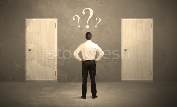 Businessman standing in front of doors Stock photo © ra2studio