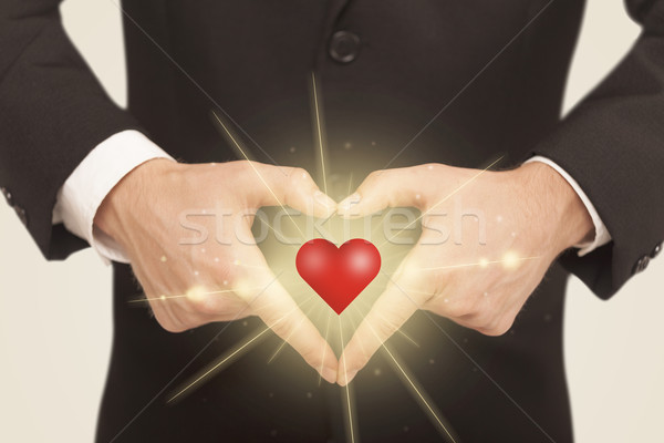 Hands creating a form with shining heart Stock photo © ra2studio