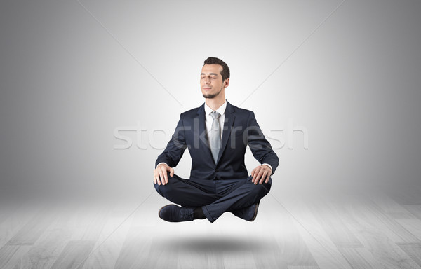 Businessman meditates in an empty space concept Stock photo © ra2studio
