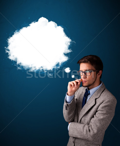 Stock photo: Young man smoking unhealthy cigarette with dense smoke