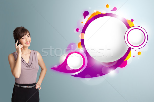 Pretty young woman presenting abstract speech bubble copy space and making phone call Stock photo © ra2studio