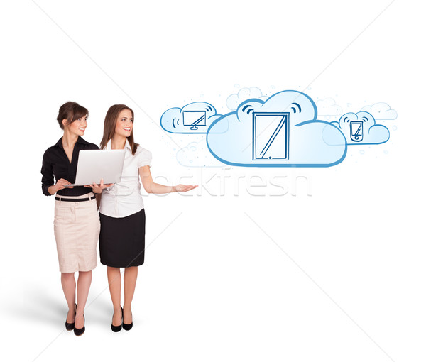 Beutiful young women presenting modern devices in clouds Stock photo © ra2studio