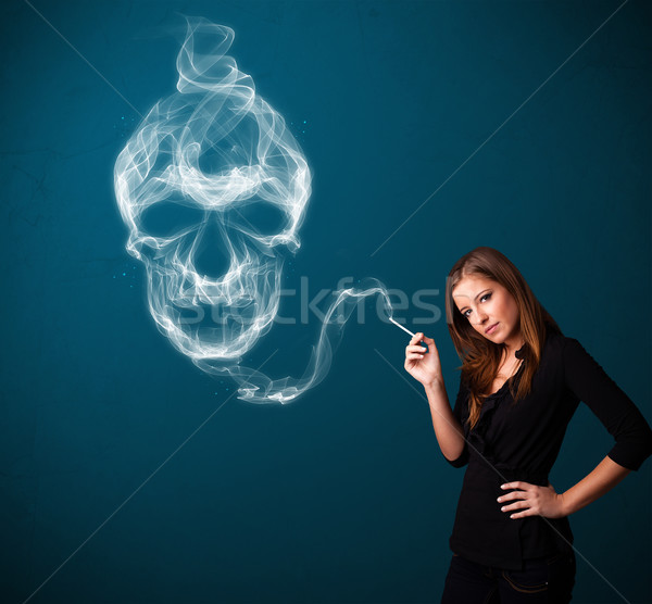 Young woman smoking dangerous cigarette with toxic skull smoke  Stock photo © ra2studio