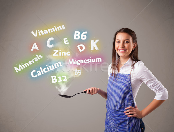 Genç kadın pişirme vitaminler mineraller güzel gıda Stok fotoğraf © ra2studio
