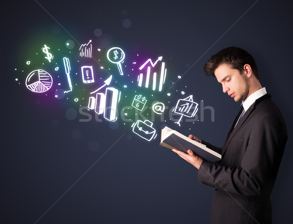 Young guy reading a book with business icons Stock photo © ra2studio