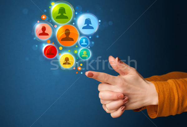 Social media icons coming out of gun shaped hand Stock photo © ra2studio